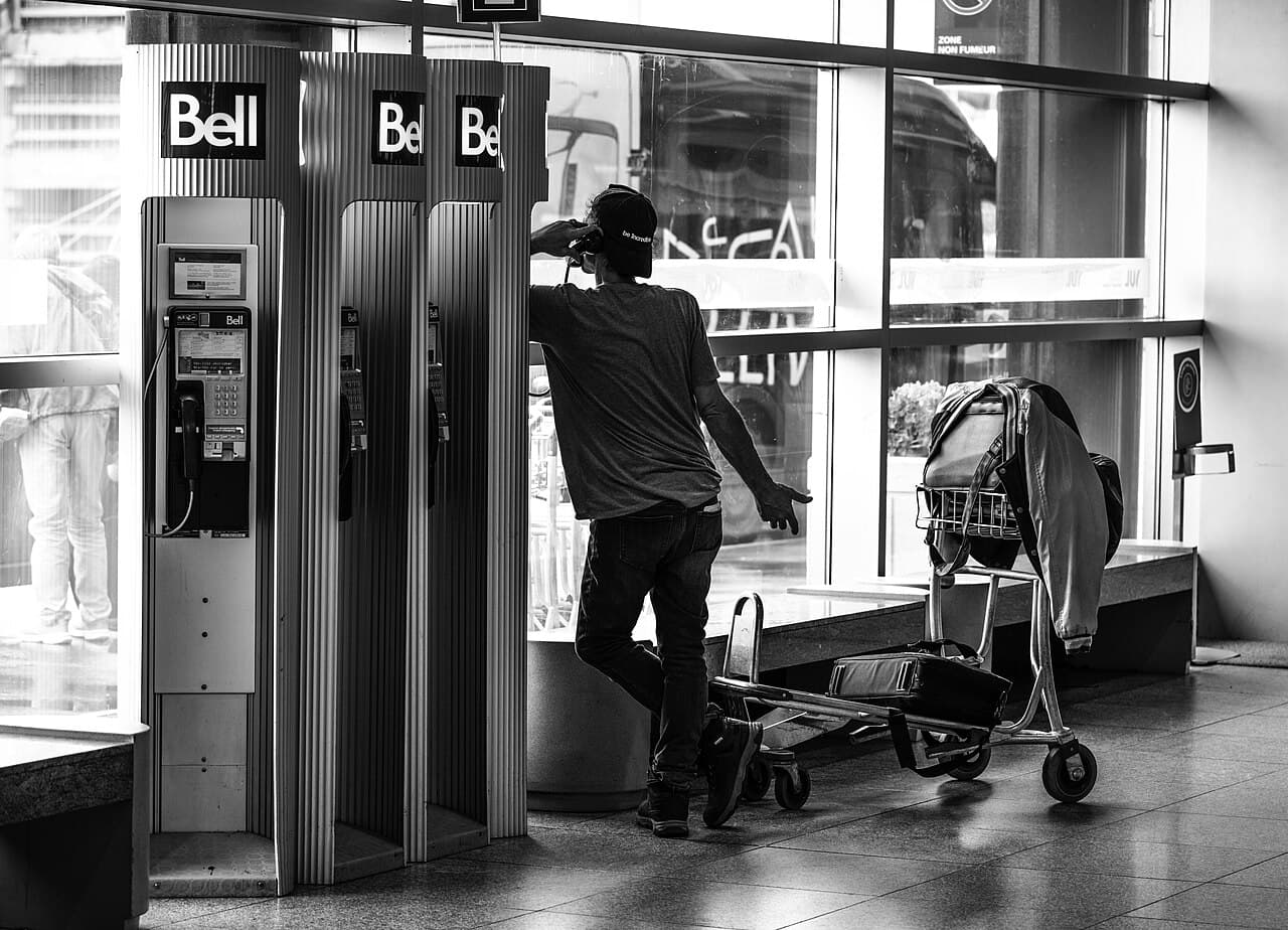Traveler using a phone in an international airport